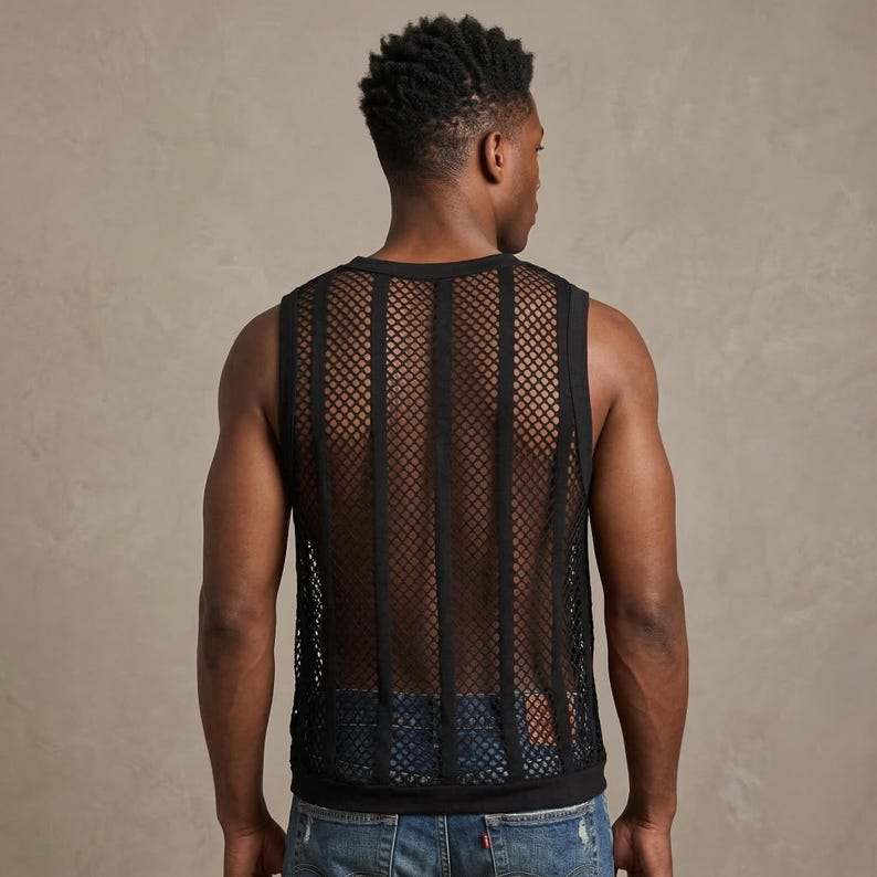 May include: Black mesh tank top with vertical stripes. The sleeveless shirt has a round neckline and a see-through design. The garment is worn over a black undershirt and paired with blue jeans.