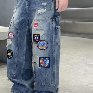 Embroidered Ripped Jeans | Denim Wide Leg Pants | Daily Wear | Retro Casual Streetwear

Distressed wide leg denim pants with embroidered patches, ripped details, and retro streetwear style.