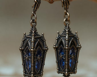 Brincos Lanterna Gótica com Cristal Azul, Pingente de Gota Prateada e Pingente de Mão em Formato de Catedral