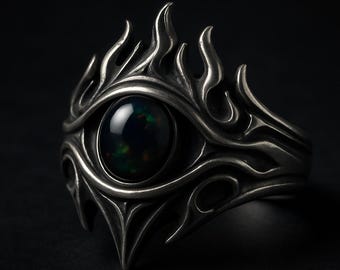 Anillo con forma de ojo y piedra de ópalo negro, banda gótica plateada con diseño de llama.