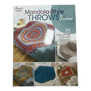 May include: A book cover titled "Mandala-Style Throws to Crochet" by Annie's Crochet. The cover features a colorful, circular crochet throw on a sofa, with additional images of textured afghans. The book promises 15 beautifully textured afghans.