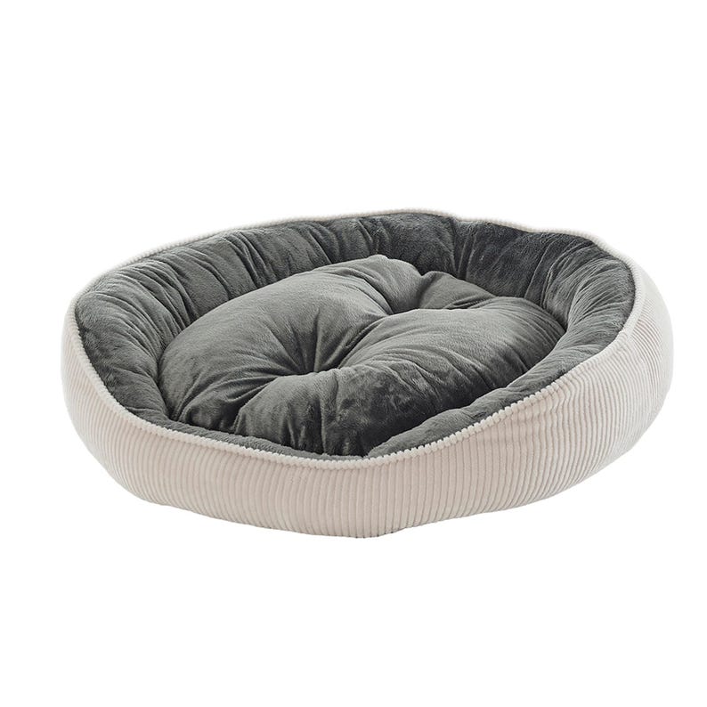 May include: An oval pet bed with a corduroy exterior in a light beige color. The interior features a plush, gray cushion. The bed is designed to provide comfort and support for small pets.