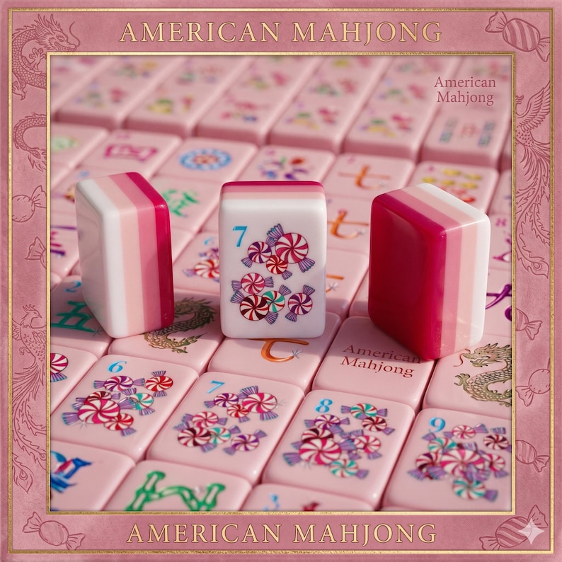 May include: A set of American Mahjong tiles in shades of pink and white. The tiles feature illustrations of colorful wrapped candies and the number 7. The set includes tiles with dragon motifs and the text American Mahjong printed on the surface.