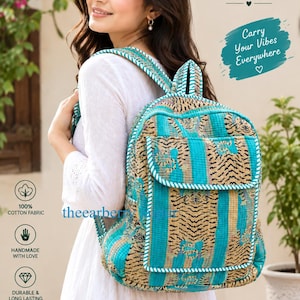 May include: A quilted fabric backpack featuring a teal and tan tiger print pattern with vertical stripes. The backpack includes a front pocket with a flap closure, adjustable shoulder straps, and white piping trim. Text on the bag reads Thearberry.