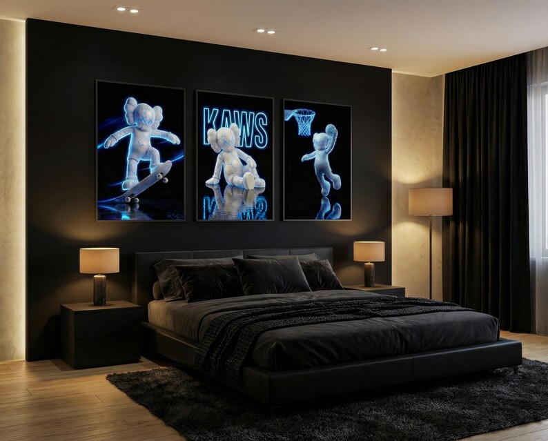 May include: Three framed art prints featuring a blue and white cartoon figure in various poses against a black background. The middle print displays the word "KAWS". The bedroom has a black bed, nightstands, lamps, and a dark rug.