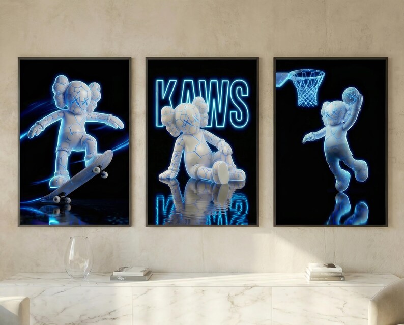 May include: Set of three framed art prints featuring a white, cartoon-like figure with blue neon outlines. One print shows the figure skateboarding, another has the word "KAWS", and the third shows the figure playing basketball. The background is black.
