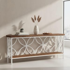 May include: A modern console table with a dark wood top and a white geometric metal base. The table features a lower shelf and is decorated with a vase, books, and a small plant. The table is approximately 60 inches long.