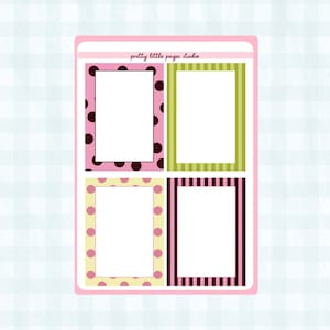 May include: A sheet of decorative stickers with four rectangular frames. The frames have various patterns, including polka dots, stripes, and solid colors, in pink, green, and brown. The text "pretty little pages studio" is at the top.