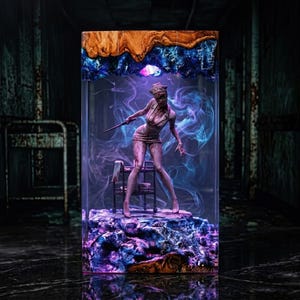 May include: A resin sculpture of a character from the Silent Hill video game series. The figure, dressed in a nurse's uniform, is holding a knife. The sculpture is encased in a clear block with a wood and blue resin top and a purple and blue base.