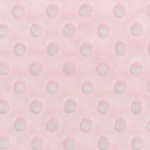 May include: A close-up of a pink fabric with a textured pattern of white dots. The fabric is soft and plush.
