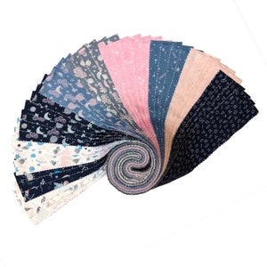 May include: A fabric roll featuring a variety of patterned cotton fabric squares. The fabrics display celestial designs in shades of blue, pink, and white. The fabrics are arranged in a spiral, showcasing the different patterns and colors.