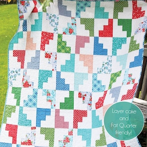 May include: A colorful quilt with a patchwork design, featuring squares in red, green, blue, and floral patterns. The quilt is labeled "Hello March" and "Cluck Cluck Sew", with text indicating it's layer cake and fat quarter friendly.