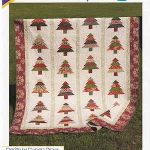 May include: A Christmas-themed quilt featuring a repeating pattern of stylized Christmas trees in red, green, and patterned fabrics on a white background. The quilt has a red floral border and the text "Tree Lot". Design by Daniela Stout.