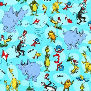 May include: A light blue fabric featuring a repeating pattern of Dr. Seuss characters including Horton the elephant, The Cat in the Hat, Thing One and Thing Two, the Lorax, and red and white kites, with the text Dr. Seuss printed throughout the design.