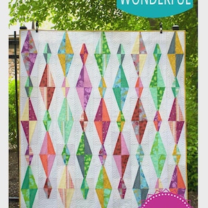 May include: A colorful quilt with a diamond pattern. The quilt features diamonds in various colors, including green, orange, purple, and yellow, set against a white background. The text "Sew Kind of Wonderful" and "Diamond Daze" are visible.