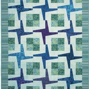 May include: A quilted blanket with a repeating pattern of blue and purple star-like shapes on a white background. The stars are interspersed with squares of green and blue floral fabric. The quilt has a striped border in shades of blue and green.