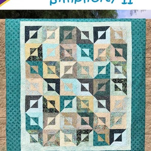 May include: A quilt with a geometric pattern in shades of teal, tan, and gray. The quilt features the text "Simplicity II" and "Cozy Quilt Designs". The design is by Daniela Stout and is a strip club pattern for 2 1/2" strips.