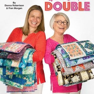 May include: Two women are holding stacks of colorful quilts. The book cover reads "3-Yard Quilts On The DOUBLE" with the text "Fabric Cafe" at the top. The book cover also includes the text "8 clever new quilt patterns! Written for 3 yards of fabric each. Instructions included for lap, twin, queen/king sizes."