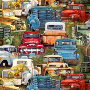 May include: A repeating pattern of vintage pickup trucks in various colors, including red, blue, yellow, and white. Some trucks have wooden bed rails and are filled with sunflowers. The trucks are set against a backdrop of green grass.