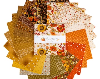 May include: A stack of square fabric swatches arranged in a circular fan pattern. The fabric features various autumn-themed prints in shades of orange, yellow, brown, and cream. A white paper band wraps the center with the text Bountiful.