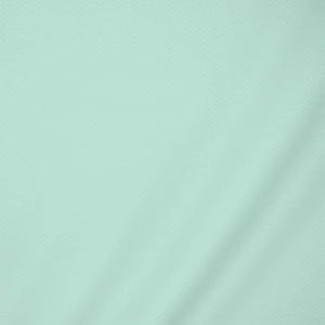 May include: A solid light mint green fabric with a subtle, uniform textured pattern across the entire surface. The material displays soft, gentle folds and shadows that highlight the consistent weave and the pale, cool-toned color of the textile.