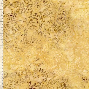 May include: Close-up of a fabric with a floral pattern in shades of gold and brown. The design features stylized flowers, leaves, and swirling vines. The fabric has a textured appearance, with variations in color and tone.