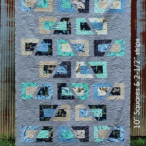 May include: A quilt pattern called "Ava" from the Stripology Mixer pattern line. The quilt is made with 10-inch squares and 2 1/2-inch strips. The quilt is a mix of blue, teal, and white fabrics. The quilt is designed by GE Designs Iceland.