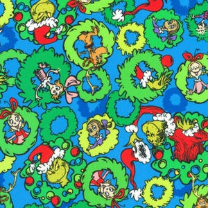 May include: A blue fabric featuring a repeating pattern of bright green Christmas wreaths. Each wreath contains a character from the Grinch story, including the Grinch wearing a red Santa hat, Max the dog, and various Whos, accented with red ornaments.