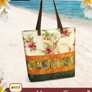 May include: A tote bag with a floral pattern, featuring pink and red flowers on a cream background. The bag has brown handles and is set against a beach scene. The text "Pink Sand Beach Designs" and "Kona Carryall" are visible.