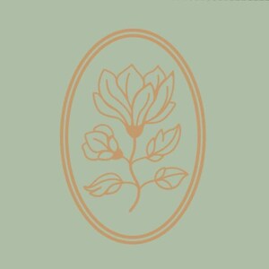 May include: A floral design in a double oval frame. The illustration features a magnolia flower with leaves and stem in a peach color, set against a muted green background. The design is simple and elegant.