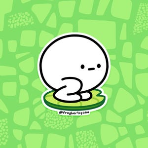 May include: A white cartoon character with a round head and small eyes and mouth, sitting on a green lily pad. The lily pad has a white outline and is on a green background with various shapes. The text "@frogbertspond" is at the bottom.