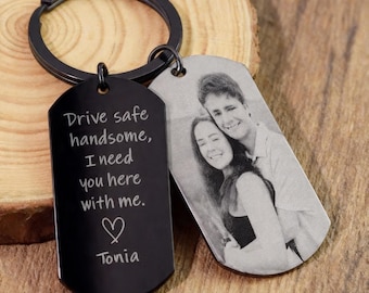 May include: Black metal keychain with two dog tag pendants. One tag has a photo of a couple, the other has the text "Drive safe handsome, I need you here with me." with a heart and the name "Tonia".