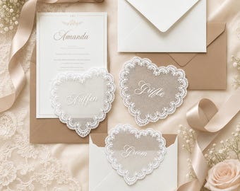 May include: A wedding stationery set featuring a white invitation card with the name Amanda, three heart-shaped translucent cards with white lace borders and the names Griffin, Griffe, and Groom, plus white and tan envelopes and silk ribbons.