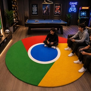 May include: A large circular area rug featuring the Google Chrome logo design with a central blue circle surrounded by red, green, and yellow segments. The rug is placed in a room with a television, a pool table, and arcade machines in the background.