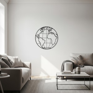 May include: A black metal wall art piece depicting a globe, mounted on a white wall. The globe features continents and grid lines, creating a modern, minimalist aesthetic. The artwork is a decorative element in a living room setting.