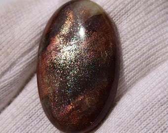 Naturalny kamień koka słoneczny w kształcie owalnego kaboszonu (26x16x5 mm), luźny kamień jakości AAA