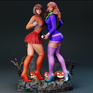 May include: A detailed figurine set featuring two characters standing on a rocky base with carved pumpkins and a tombstone. One character wears an orange turtleneck, red skirt, and red heels, holding a magnifying glass. The other wears a purple dress, light purple thigh-high boots, and blue heels.
