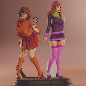 May include: A detailed sculpture featuring two female characters. One wears an orange turtleneck, skirt, and boots, holding a magnifying glass. The other is in a purple dress, green scarf, and pink thigh-highs. Both figures stand on a decorative base.