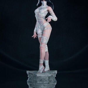 May include: A white figure with long black hair and a face covering stands on a stone pedestal. The figure wears a form-fitting outfit with a grid-like pattern and wrapped bandages. The pose is elegant, with one hand gracefully placed.