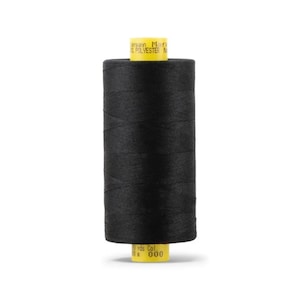May include: A spool of black thread, likely polyester, with a yellow label. The label includes the brand name "Gutterman Mara" and the thread's length in yards. The thread is tightly wound around the spool.