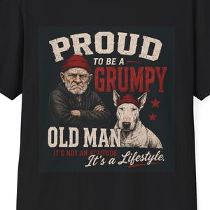 May include: A black short-sleeved t-shirt featuring a graphic print of an older person and a bull terrier dog, both wearing red beanies. The text reads: PROUD TO BE A GRUMPY OLD MAN. IT'S NOT AN ATTITUDE. IT'S A LIFESTYLE. The design includes two red stars.