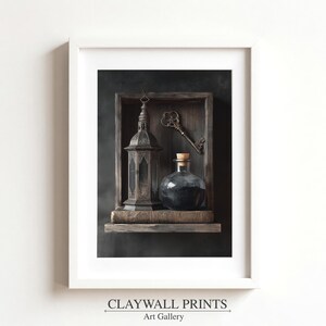 May include: A framed art print featuring a dark, moody still life. A vintage lantern, a glass bottle with a cork stopper, and an antique key are displayed on a wooden shelf. The print is labeled "CLAYWALL PRINTS Art Gallery."