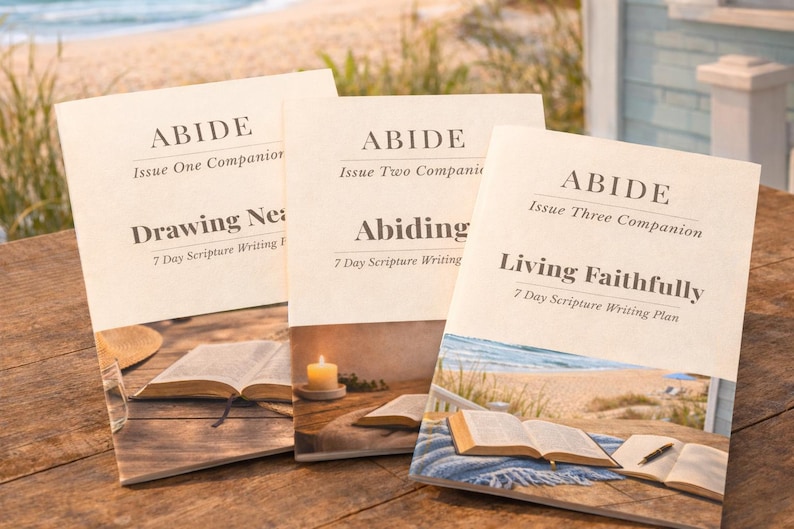 Peut inclure: Trois livres compagnons intitul&eacute;s "ABIDE" avec les textes "Drawing Near", "Abiding" et "Living Faithfully". Chaque livre pr&eacute;sente une illustration de livre ouvert et une sc&egrave;ne de plage. Les livres sont sur une surface en bois.