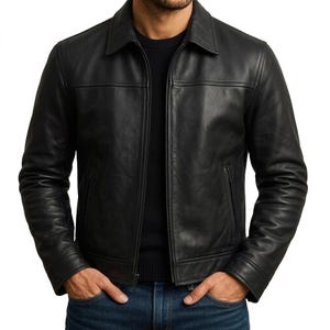 May include: A black leather jacket with a collared neckline and a front zipper closure. The jacket has two side pockets and a tailored fit. The model is wearing a black sweater and blue jeans.