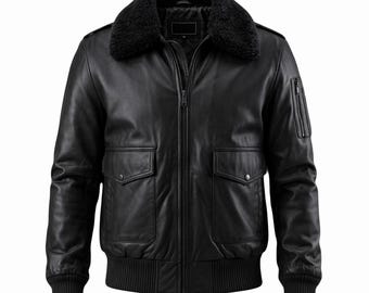 May include: Black leather bomber jacket with a black faux fur collar. The jacket features a zip-up front, two front pockets with flaps, and a ribbed hem and cuffs. A small zippered pocket is on the left sleeve.