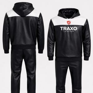 May include: Black and white leather hoodie and matching pants set. The hoodie has a white panel across the shoulders and hood, with the text "TRAXO LEATHER" printed on the chest. The set is made of a smooth, shiny material.