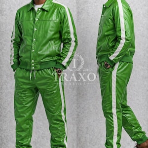 May include: A green leather tracksuit with white stripes down the sleeves and legs. The jacket has a button-up front and a collar. The pants have a drawstring waist. The brand name "TRAXO LEATHER" is visible.