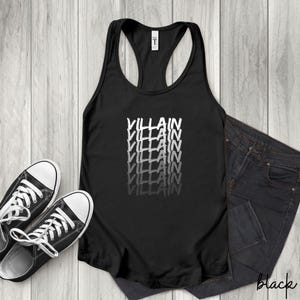 May include: Black racerback vest with the word "VILLAIN" stacked vertically in a white, distressed font. The vest is paired with black jeans and black canvas trainers with white laces and soles. The word "black" is written on the jeans.