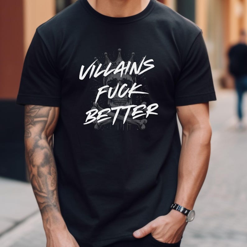 May include: Black t-shirt with the text "Villains Fuck Better" in white, featuring a skull with a crown and crossbones design. The shirt is short-sleeved and made of a soft material.
