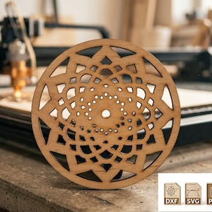 May include: A round, wooden coaster with a detailed, openwork design. The coaster features a central spiral pattern surrounded by geometric shapes. The wood has a natural, light brown color. The image also shows a laser cutter and file type icons.